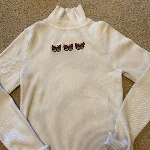 White embroidered butterfly turtleneck